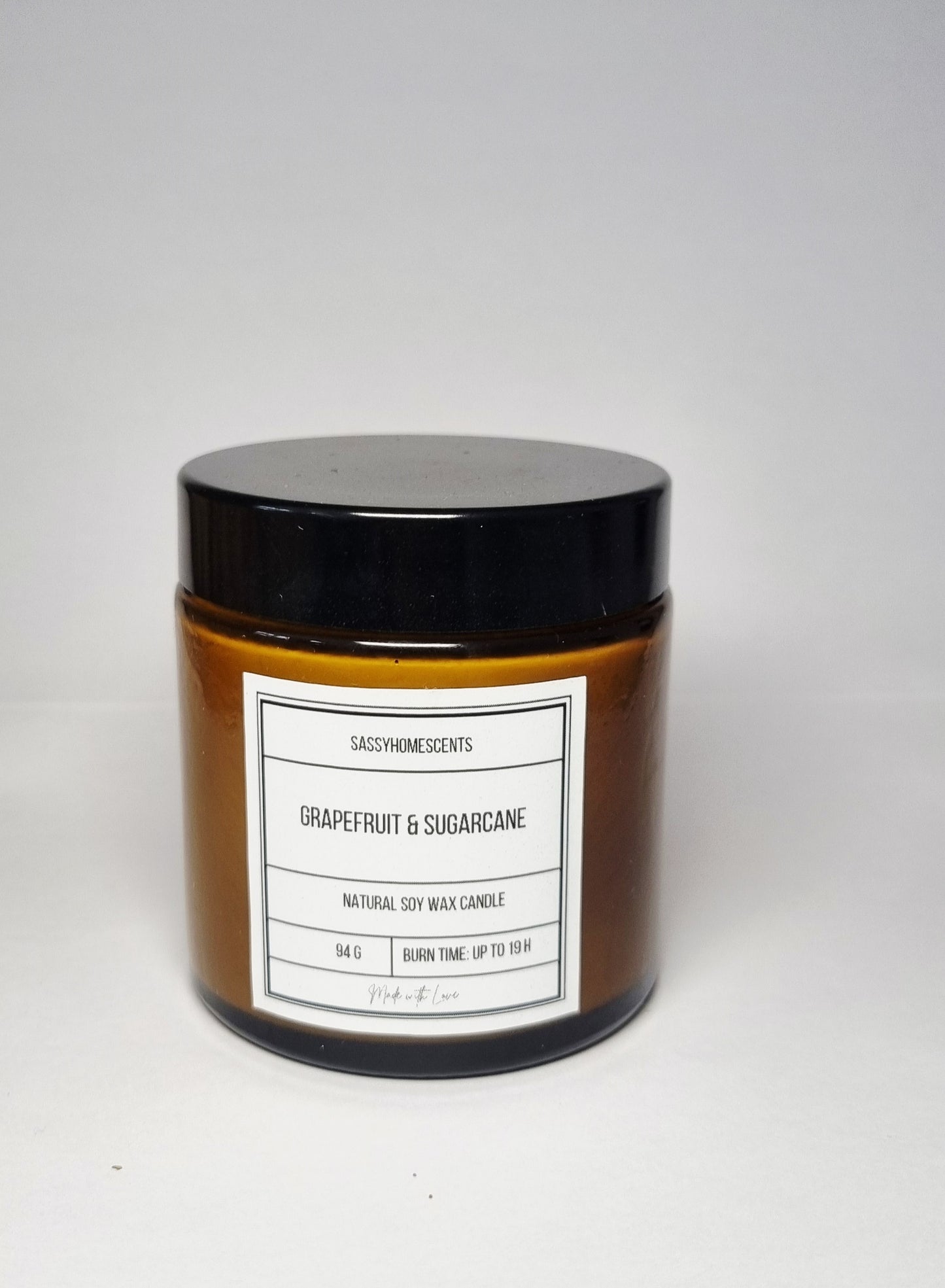 grapefruit and sugarcane scented candle in glass jar with organic cotton wick