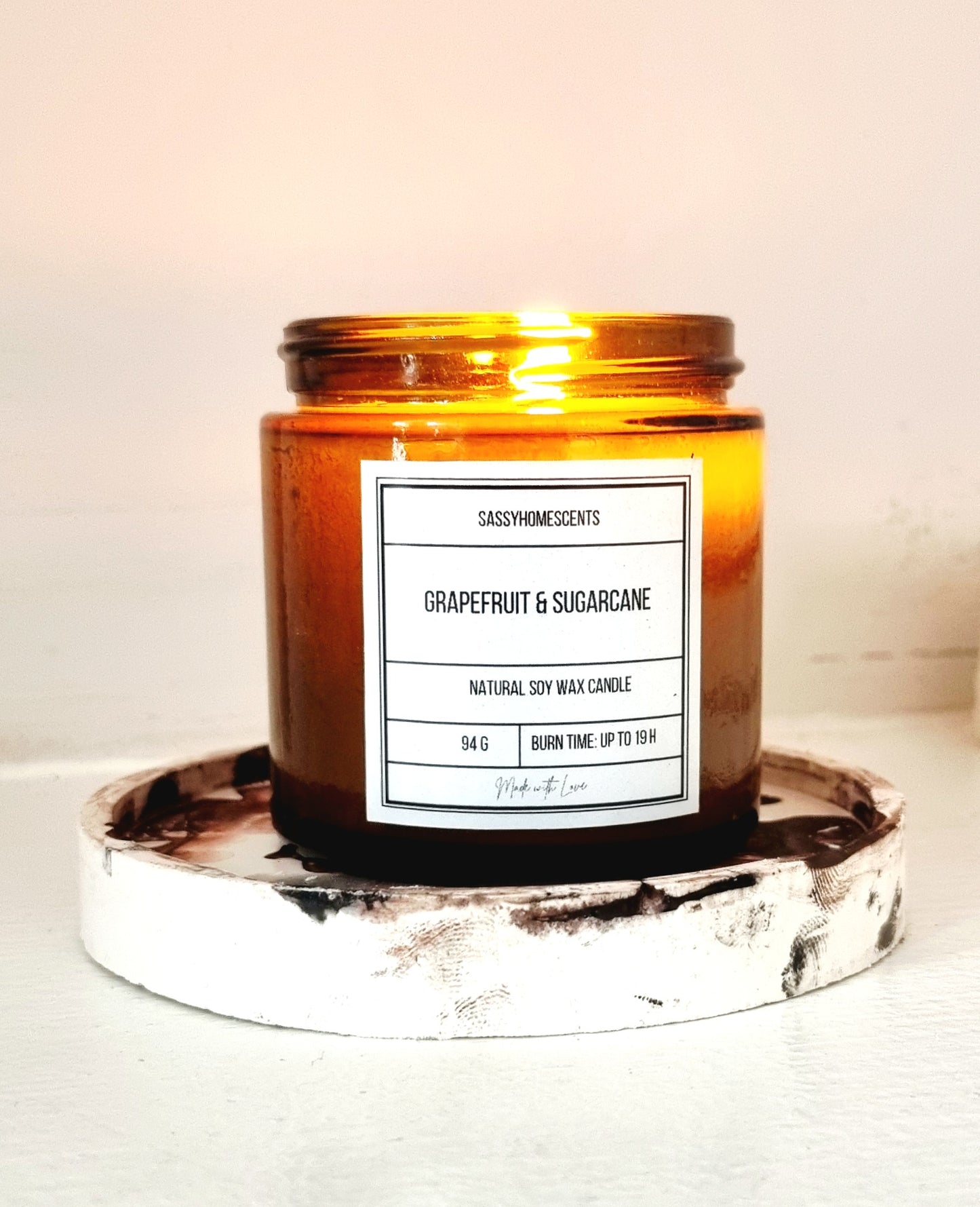 grapefruit and sugarcane scented candle in glass jar with organic cotton wick