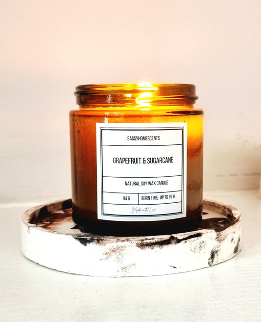 grapefruit and sugarcane scented candle in glass jar with organic cotton wick