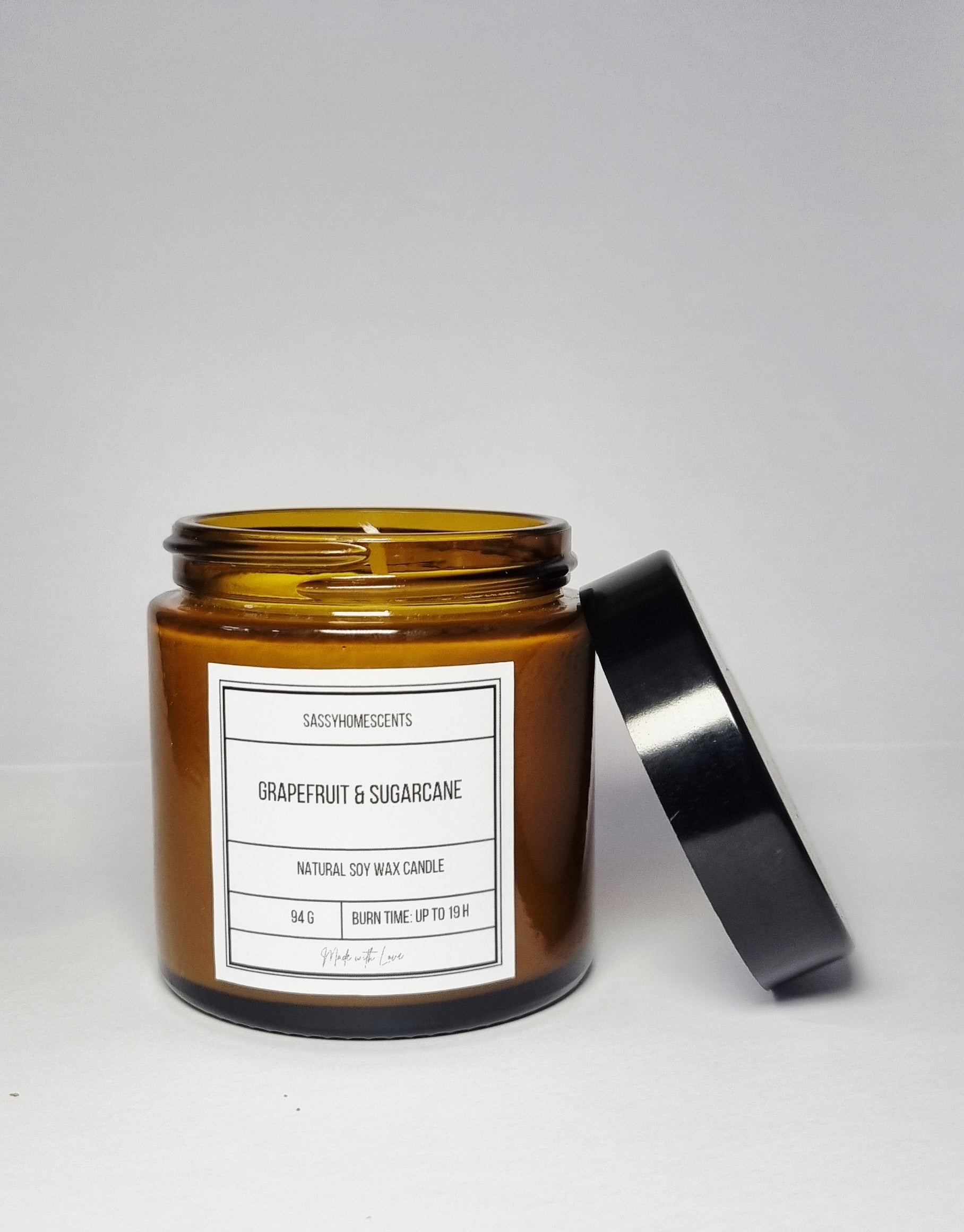 grapefruit and sugarcane scented candle in glass jar with organic cotton wick