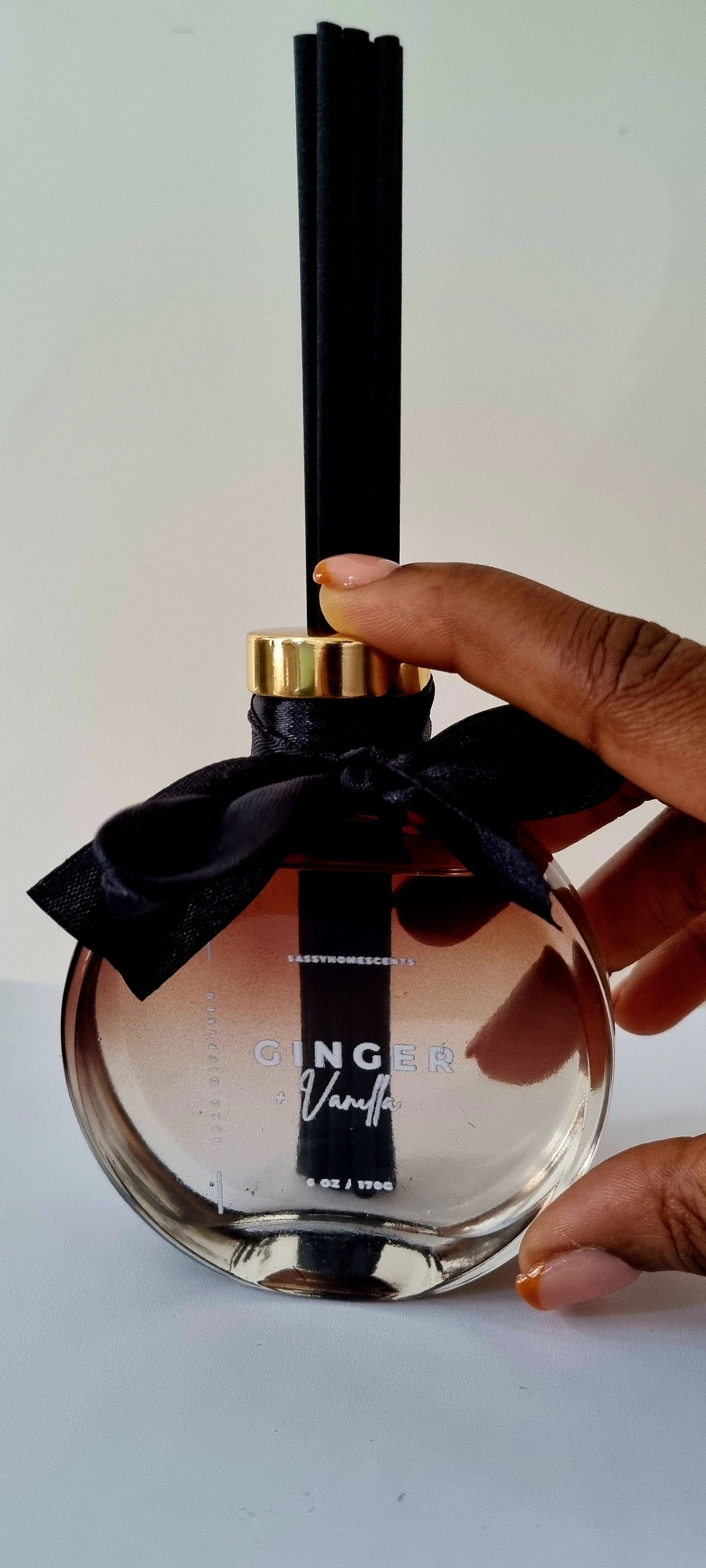 Ginger and vanilla reed diffuser in glass bottle with natural reeds for warm home fragrance