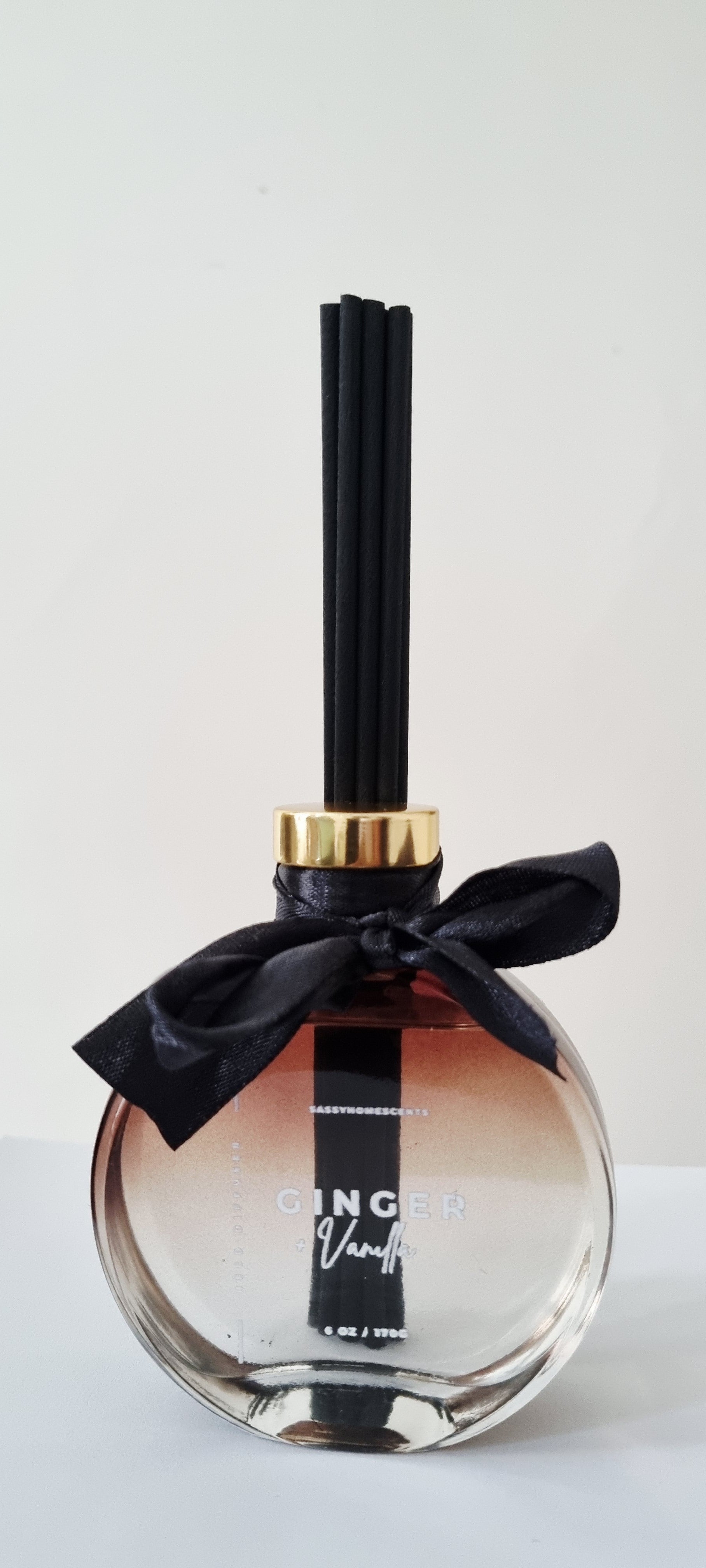 Ginger and vanilla scented reed diffuser on shelf